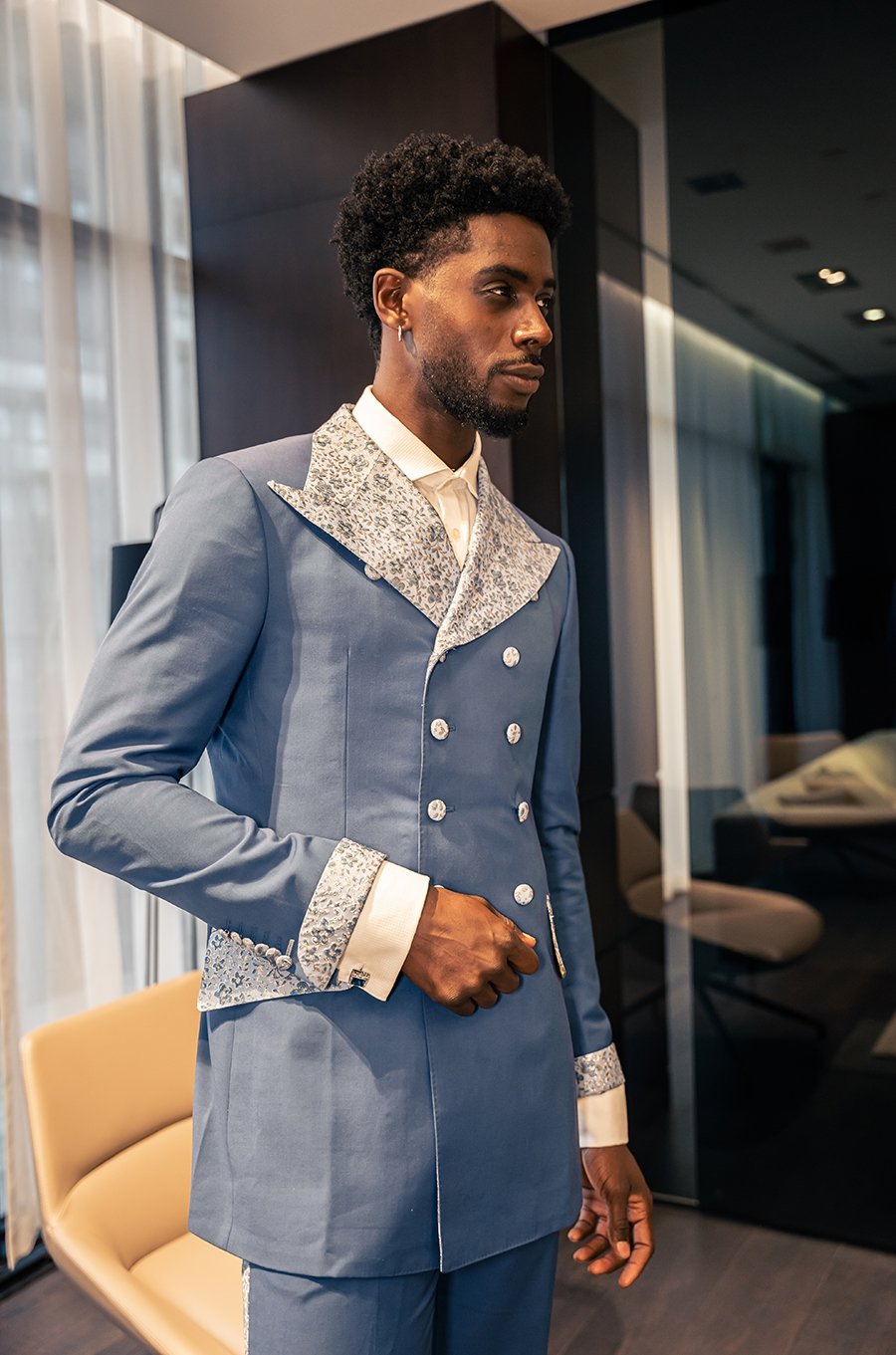 Nalikem azure double-breasted poly-wool suit with textured fabric on lapel. Decorated with custom textured buttons and pockets.